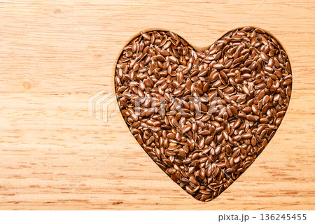 Raw flax seeds linseed heart shaped Raw flax seeds linseed heart shaped 136245455