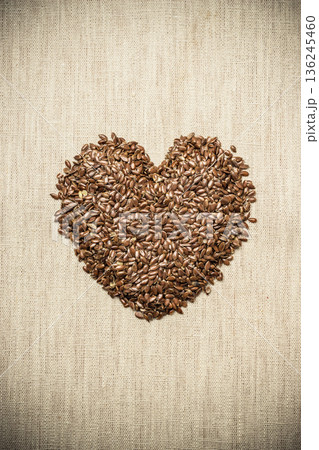 Raw flax seeds linseed heart shaped Raw flax seeds linseed heart shaped 136245460