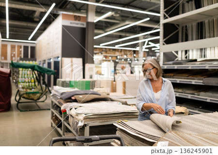 Woman shopping for home decor items in a modern store during a busy afternoon Woman shopping for home decor items in a modern store during a busy afternoon 136245901
