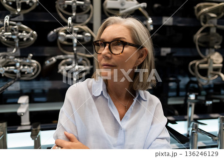Woman exploring modern kitchen appliances in a stylish showroom during the afternoon Woman exploring modern kitchen appliances in a stylish showroom during the afternoon 136246129