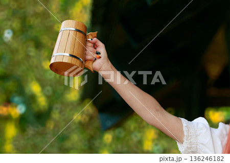 medieval role play cheers concept woman hand rise goblet of beer on role play game activity with blurred background space 136246182