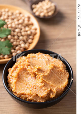 Traditional Japanese miso paste in a black bowl. Healthy fermented soybean seasoning for cooking 136254778