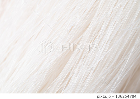 Close-up texture of dried glass noodles, macro background of transparent mung bean vermicelli 136254784