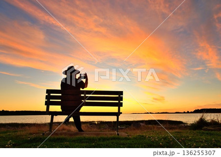 Man Taking A Photo of A Wonderful Summer Sunset Foxton Beach New Zealand 136255307