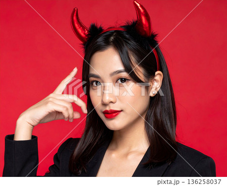 ハロウィンのコスプレで悪魔のツノをつけた若い女性 136258037