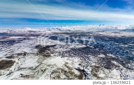A snowy landscape with a blue sky in the background A snowy landscape with a blue sky in the background 136259021