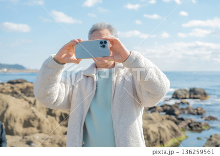 海岸をスマートフォンで撮影する男性 海岸をスマートフォンで撮影する男性 136259561