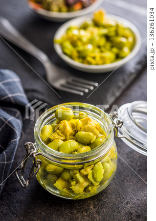 Fresh salad with edamame beans in jar on black table. Fresh salad with edamame beans in jar on black table. 136261034