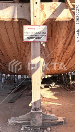 Restoration Specialist Inspects Weathered Wooden Ship Structure And Repairs. Shipyard Worker Meticulously Assesses Aged Timber And Metal Components During Preservation Process Restoration Specialist Inspects Weathered Wooden Ship Structure And Repairs. Shipyard Worker Meticulously Assesses Aged Timber And Metal Components During Preservation Process 136262270