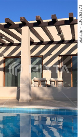 Bright Tranquil Retreat. Sundrenched Outdoor Structure Showcasing Calm Reflective Surfaces And Modern Minimalist Architectural Style For Peaceful Vacation Atmosphere Bright Tranquil Retreat. Sundrenched Outdoor Structure Showcasing Calm Reflective Surfaces And Modern Minimalist Architectural Style For Peaceful Vacation Atmosphere 136262273