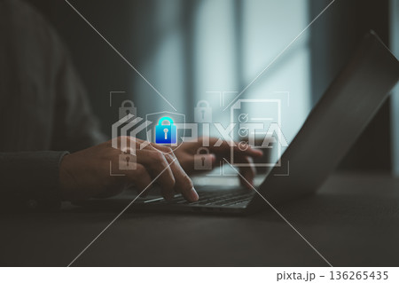 Typing on laptop keyboard with digital lock icons illustrating cybersecurity and data protection Typing on laptop keyboard with digital lock icons illustrating cybersecurity and data protection 136265435