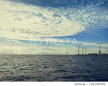Wind turbines power generator farm along coast sea 136266560
