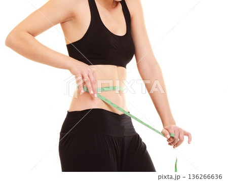 diet. slim fit girl with measure tape measuring waist diet. slim fit girl with measure tape measuring waist 136266636