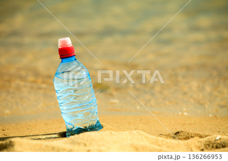 bevarage. bottle of water drink on a sandy beach. 136266953