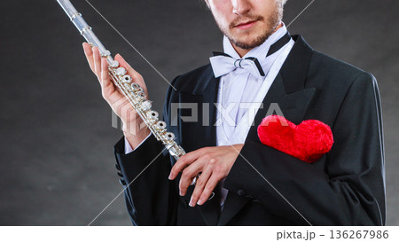 Male flutist with flute and heart. Love melody Male flutist with flute and heart. Love melody 136267986