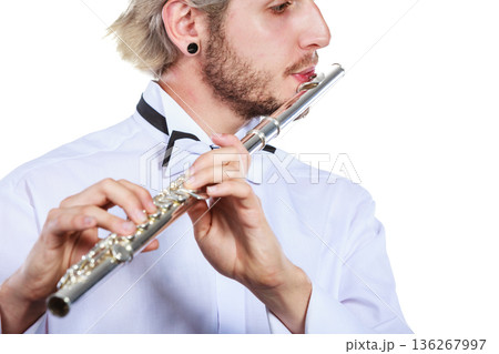 Male flutist playing his flute Male flutist playing his flute 136267997