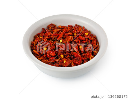 Dried red chili flakes in white bowl on white background 136268173