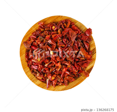 Dried red chili flakes in wooden bowl Dried red chili flakes in wooden bowl 136268175