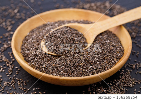 Chia seeds as superfood in wooden bowl with spoon Chia seeds as superfood in wooden bowl with spoon 136268254