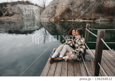 Couple enjoying a romantic moment on a dock by the water on Valentines Day 136268612