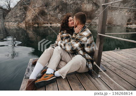 Couple enjoying a moment together on a dock by the water during Valentines Day 136268614