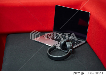 Laptop with Headphones on Red Cushion 136270441