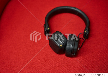 Stylish Over-Ear Headphones on Red Background 136270445