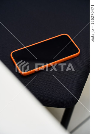 Smartphone on Fabric Background - Modern Device Shot Smartphone on Fabric Background - Modern Device Shot 136270471
