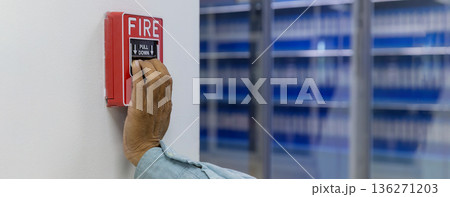 Activate fire alarm trigger system which is installed on granite wall of the building. 136271203