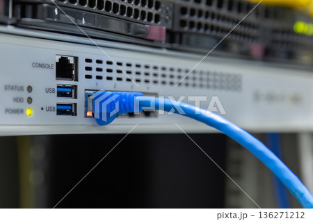 Network cables connected to switches. 136271212