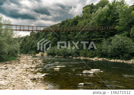 Suspension Bridge Over Mountain River in Forest Landscape Suspension Bridge Over Mountain River in Forest Landscape 136271512