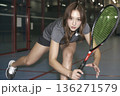 Woman is playing tennis with a racket 136271579