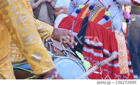 Dhol drummer playing traditional Indian music during a cultural festival celebration Dhol drummer playing traditional Indian music during a cultural festival celebration 136272695