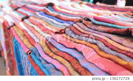 India market stall displaying colorful pashmina textiles and traditional patterned fabrics 136272726