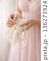 Elegant Woman in Lavender Dress Handling Pearl Jewelry and Lace 136273924