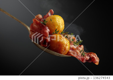 Roasted potatoes with bacon and thyme. 136274543
