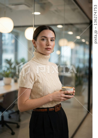A photo portrait of an elegant woman, wearing a beige turtleneck sweater holding coffee cup while 136274753