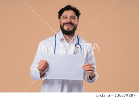 Smiling Male Doctor Holding Blank A4 Paper with Copy Space. healthcare promotion Smiling Male Doctor Holding Blank A4 Paper with Copy Space. healthcare promotion 136274897