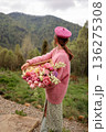 Woman holding tulips in mountain landscape 136275308