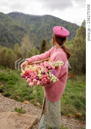 Woman holding tulips in mountain landscape 136275308