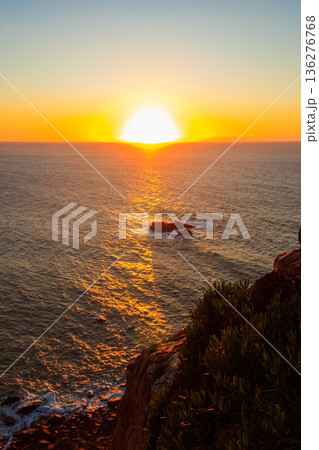 View of the Atlantic Ocean from Cabo da Roca at sunset. Cabo da Roca or Cape Roca is westernmost cape of mainland Portugal, continental Europe and the Eurasian land mass 136276768