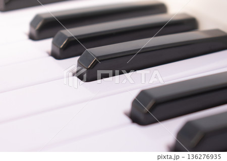 Macro view of piano keys on black background, close up musical instrument keyboard for classical concert poster, harmony and song composition concept Macro view of piano keys on black background, close up musical instrument keyboard for classical concert poster, harmony and song composition concept 136276935