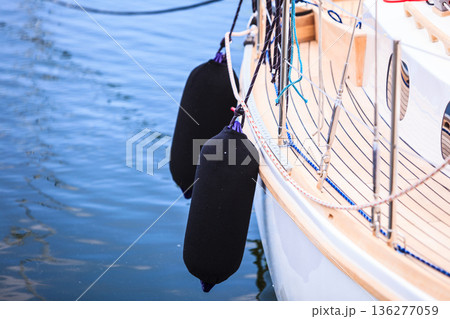 Side of hull sailboat with black fenders Side of hull sailboat with black fenders 136277059