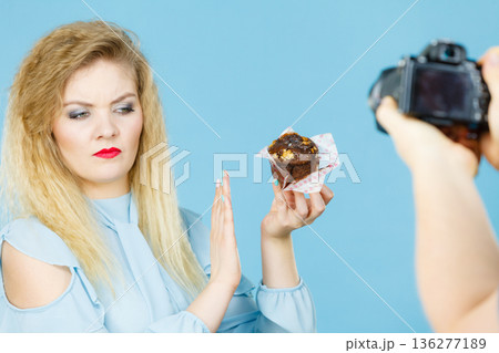 Woman refuses to eat chocolate cupcake 136277189