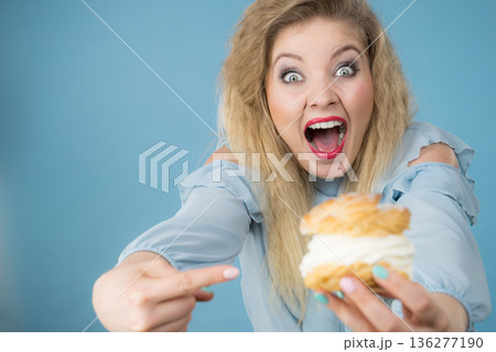 Funny woman holds cream puff cake 136277190