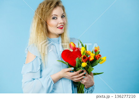 Woman holds tulips and red heart 136277210