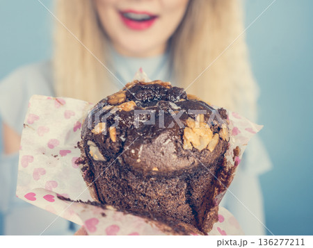 Attractive woman holds cake in hand 136277211