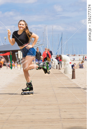 Roller skate woman eating ice cream 136277374