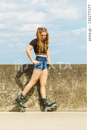 Fit girl with roller skates outdoor Fit girl with roller skates outdoor 136277377