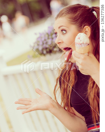 Young woman eating ice cream Young woman eating ice cream 136277386